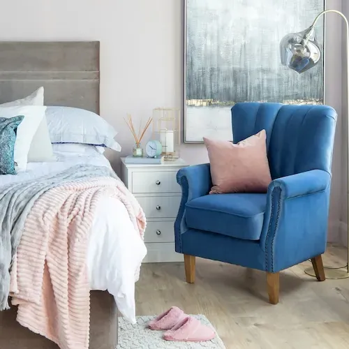 Measuring floor space to correctly position a bedroom chair near a sunny window.