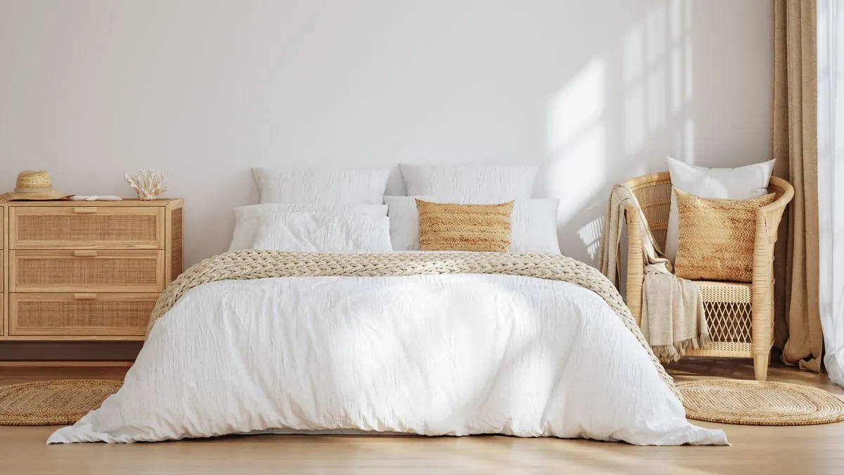A modern chair with open legs creates the illusion of more space in a bedroom.