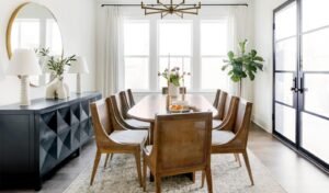 A modern dining table defines the center of a spacious, open-concept home interior.