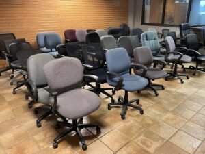 A modern ergonomic office chair sits in a bright and minimalist home office.