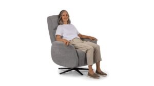 A modern lift chair sits in a bright, cozy living room interior.