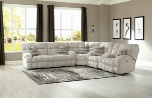 A modern sectional couch sits in a bright and airy living room space.
