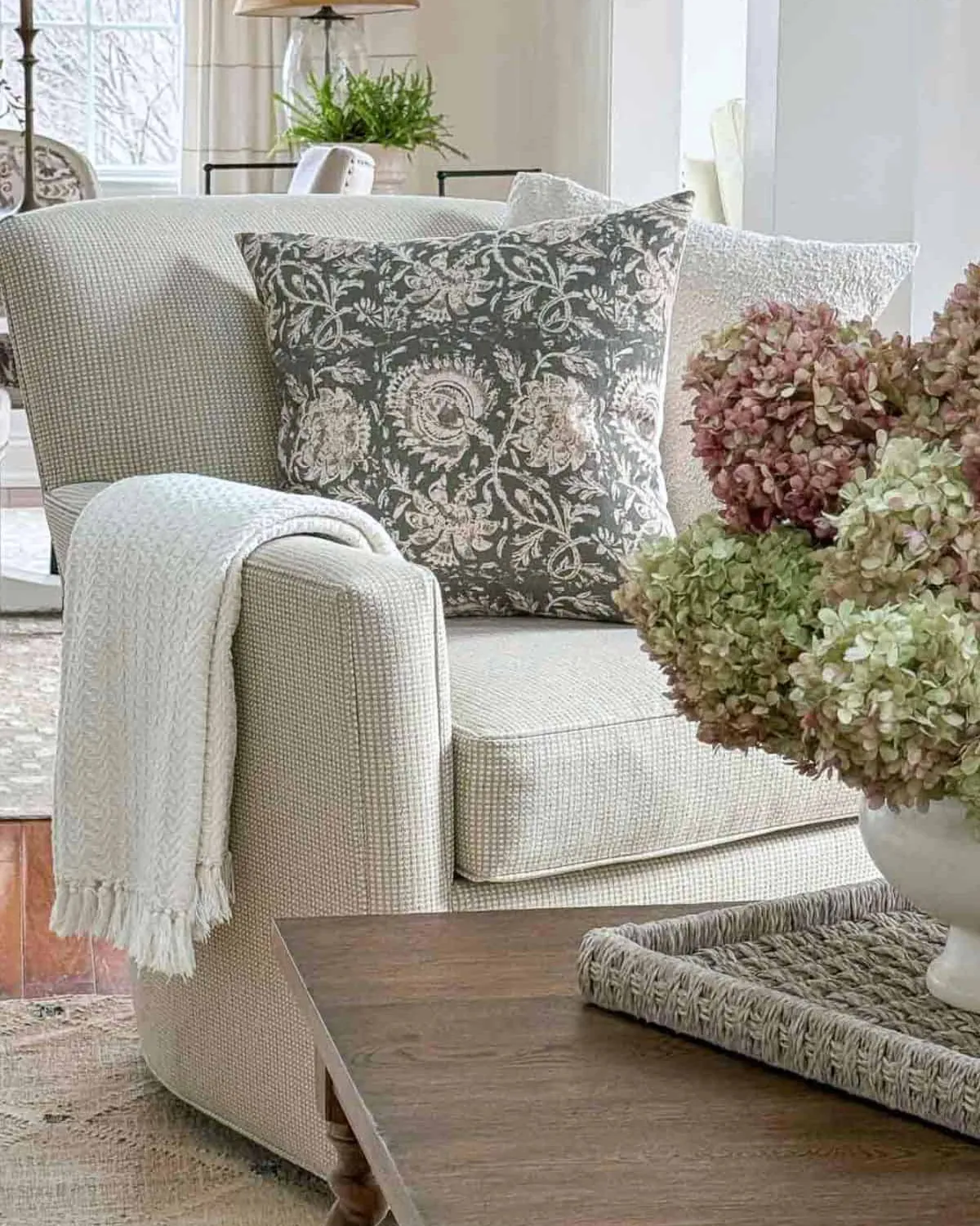 A modern skirted swivel chair next to a retro chair with a metal base.