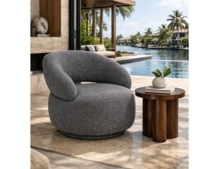 A modern swivel chair stands in a sunlit home office workspace.
