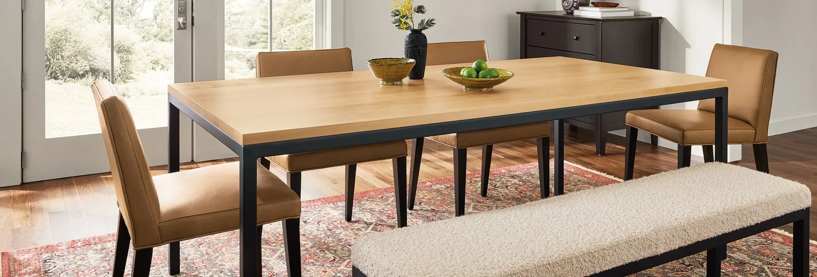 An oak dining table acts as an anchor in an open-plan living space.