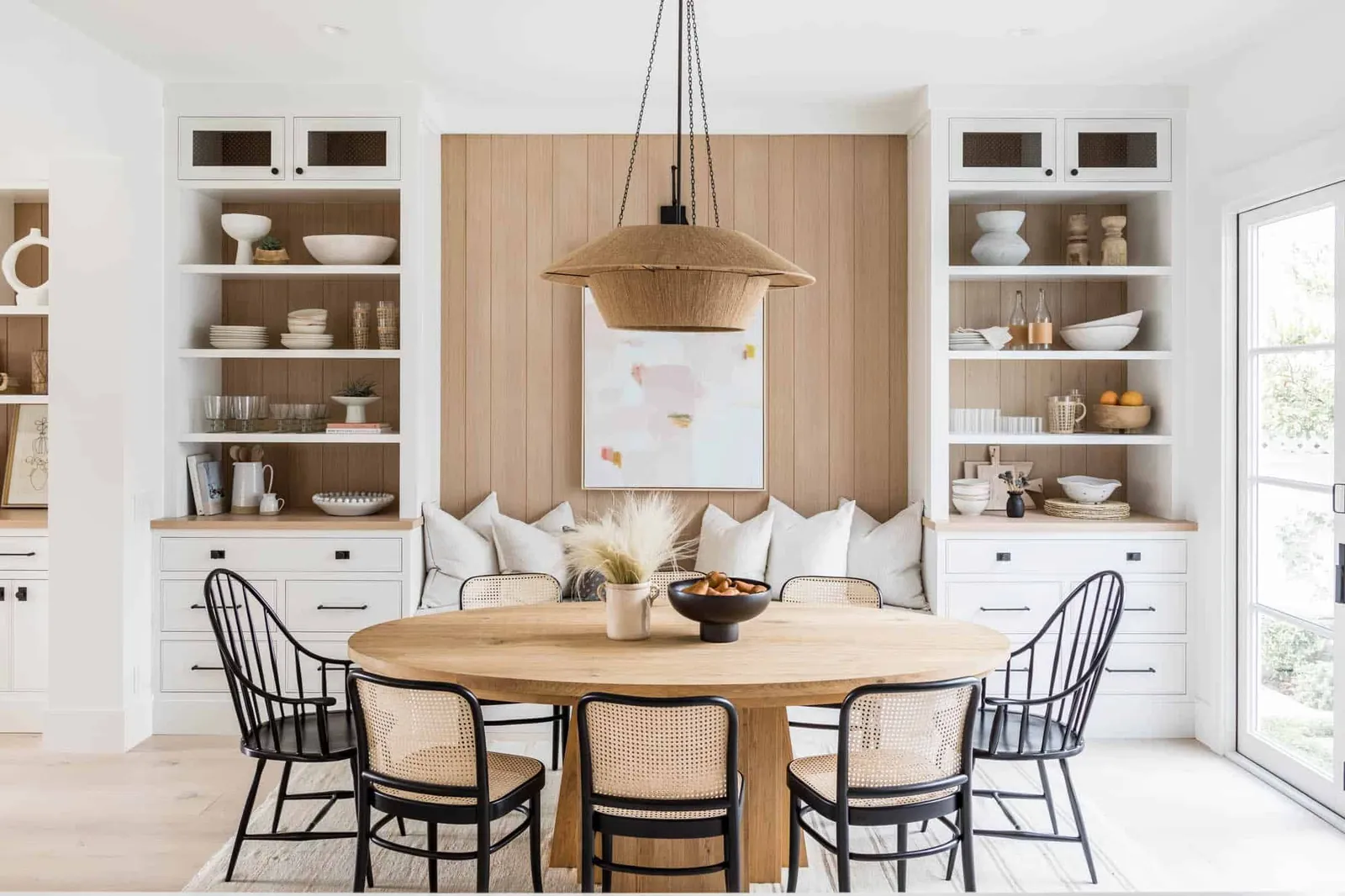 An oversized dining table blocks a walkway in a poorly planned dining room.