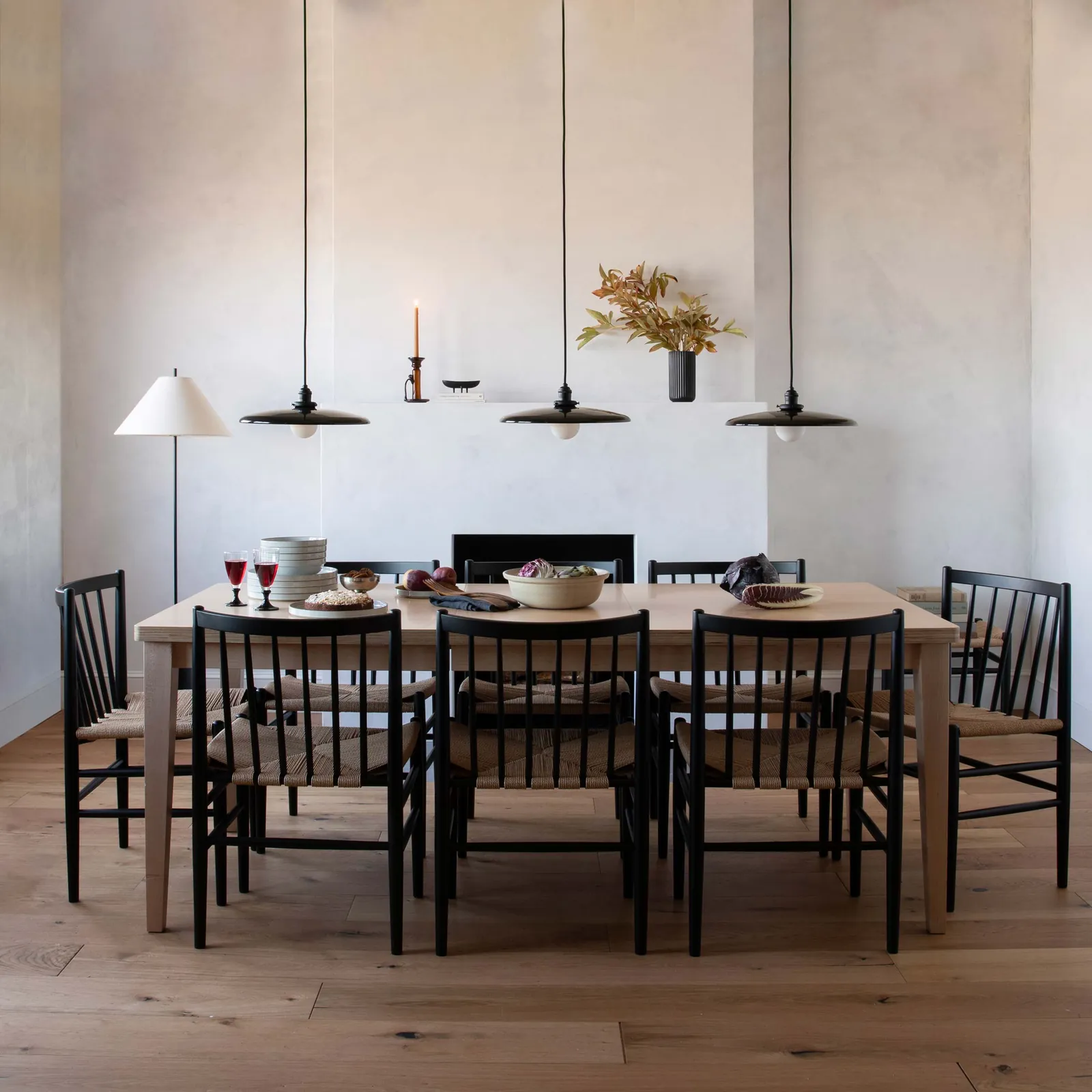 An oversized dining table creates a cramped look by blocking walkway space in a room.