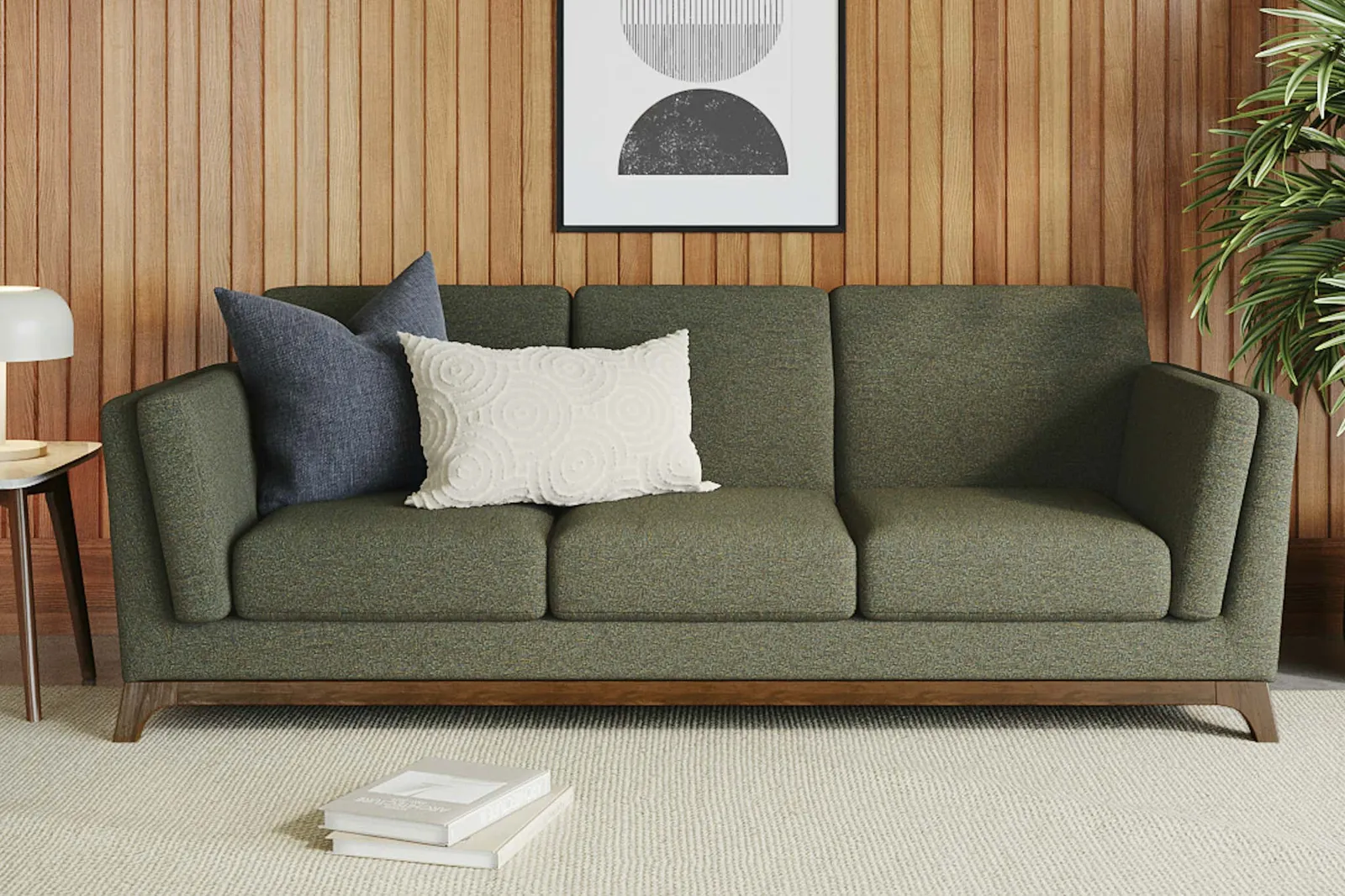 A person measuring a sofa to ensure it fits in their living room.