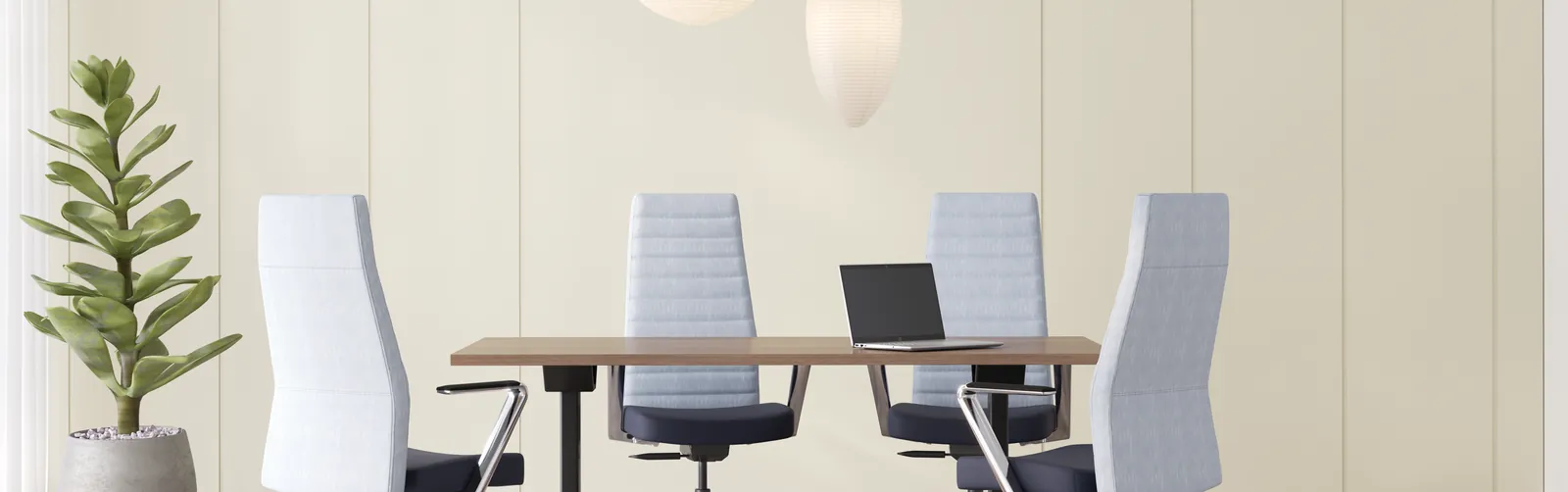 Person sitting in a conference chair with correct ergonomic posture.