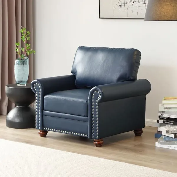 A plush navy blue velvet barrel chair in a cozy bedroom corner setting.