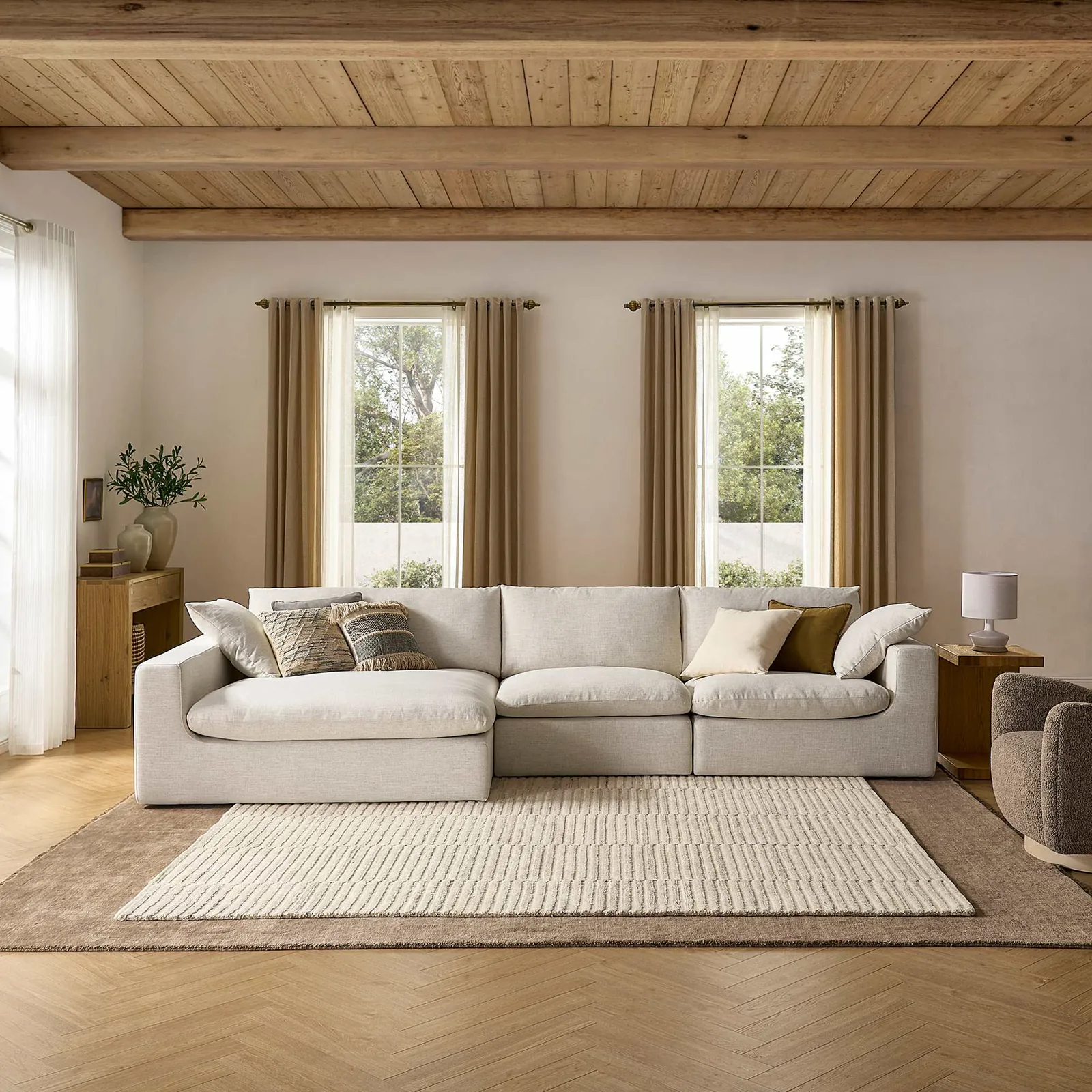 A poorly placed sectional sofa blocks a heating vent and a narrow walkway.