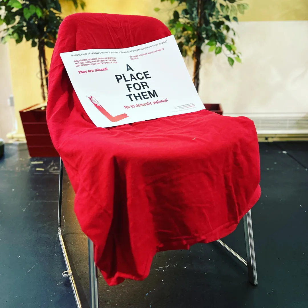 A poorly staged red chair in a cluttered environment showing a storytelling mistake.