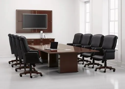 A premium high-back executive leather chair positioned in a formal boardroom setting.