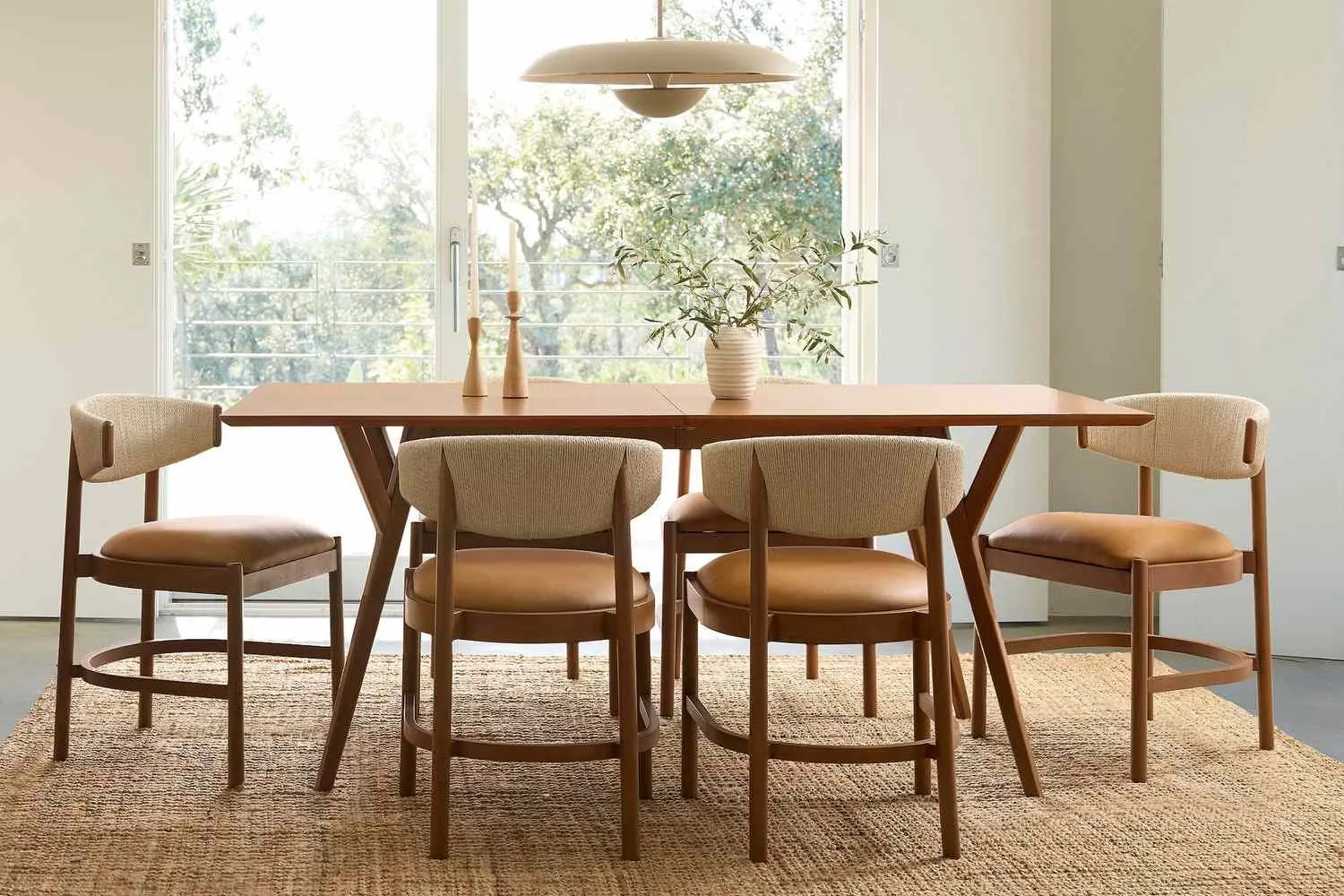 A rectangular dining table centered in a room with ample space for chairs.