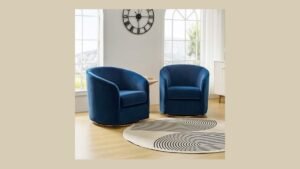 A stylish navy blue accent chair set in a bright modern living room.