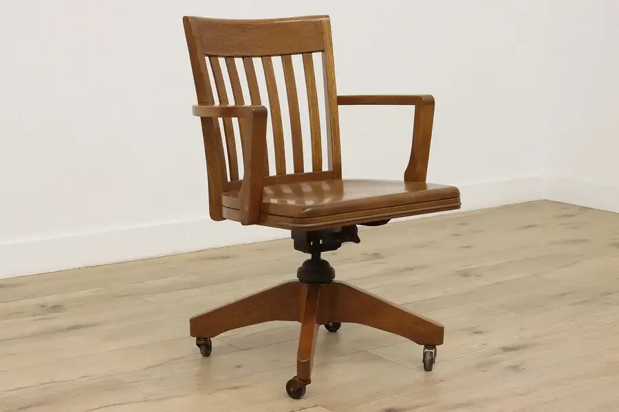 A tape measure checking the height between a desk and a budget chair.