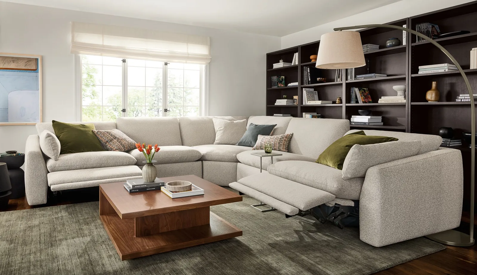 A tape measure on a hardwood floor measuring space for a new sofa.