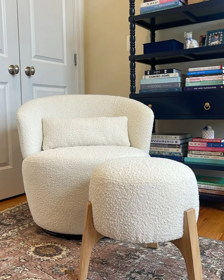Testing a bedroom chair for stability and taut fabric before final placement.