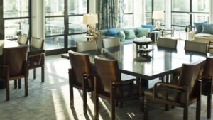 Two distinct dining tables arranged harmoniously in a spacious, sunlit modern home interior.