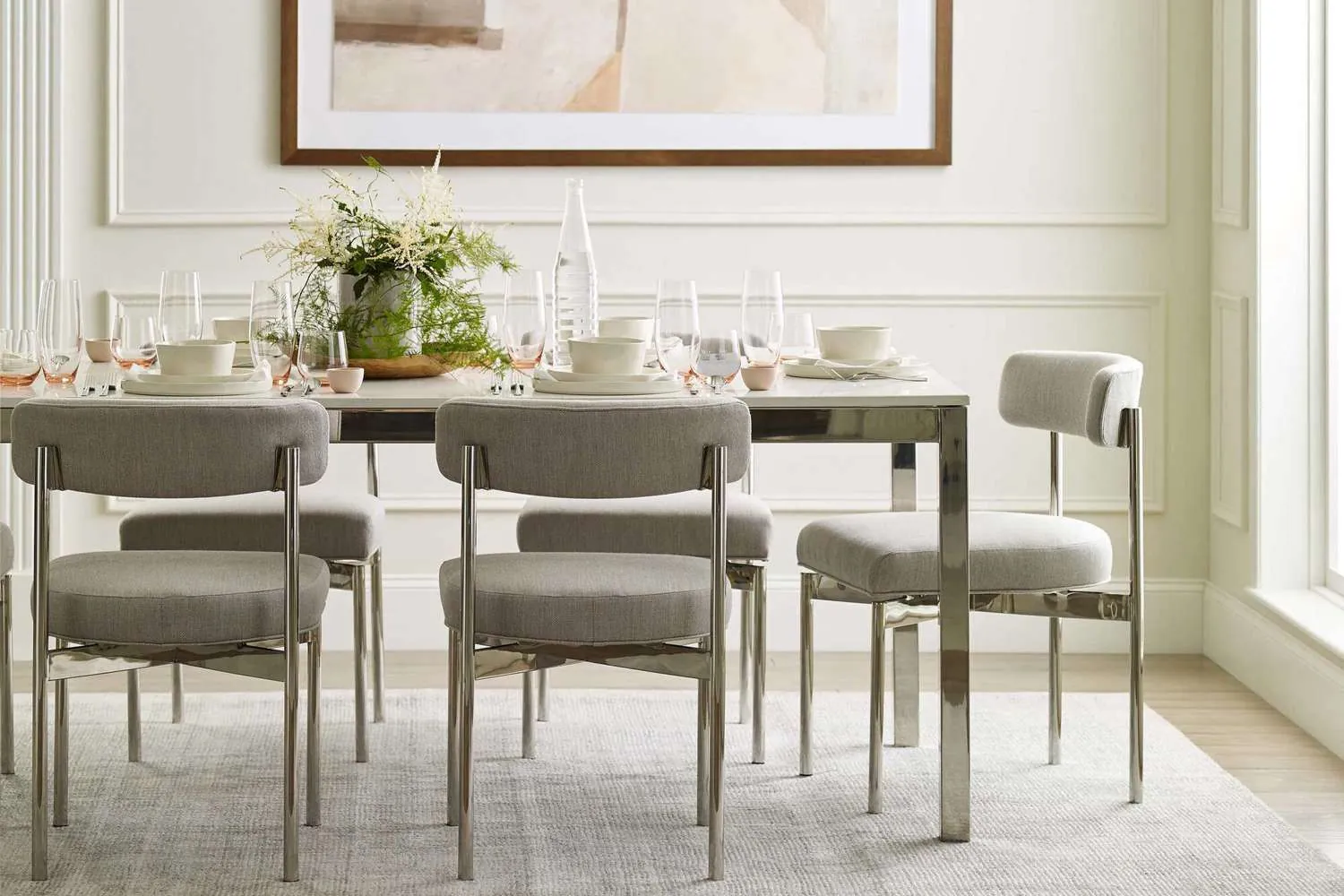 Various dining table sets arranged inside a spacious modern furniture showroom floor.