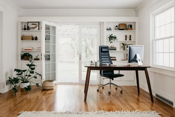 Various home office furniture options displayed for comparison in a studio.