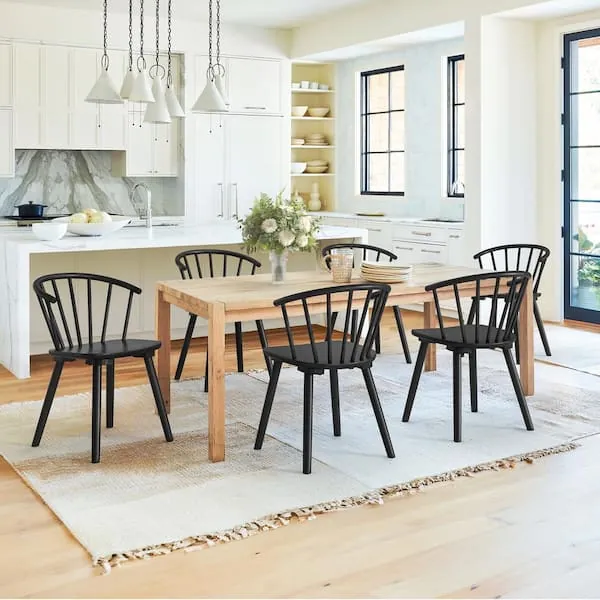 Various styles of kitchen chairs displayed together in a bright modern showroom.