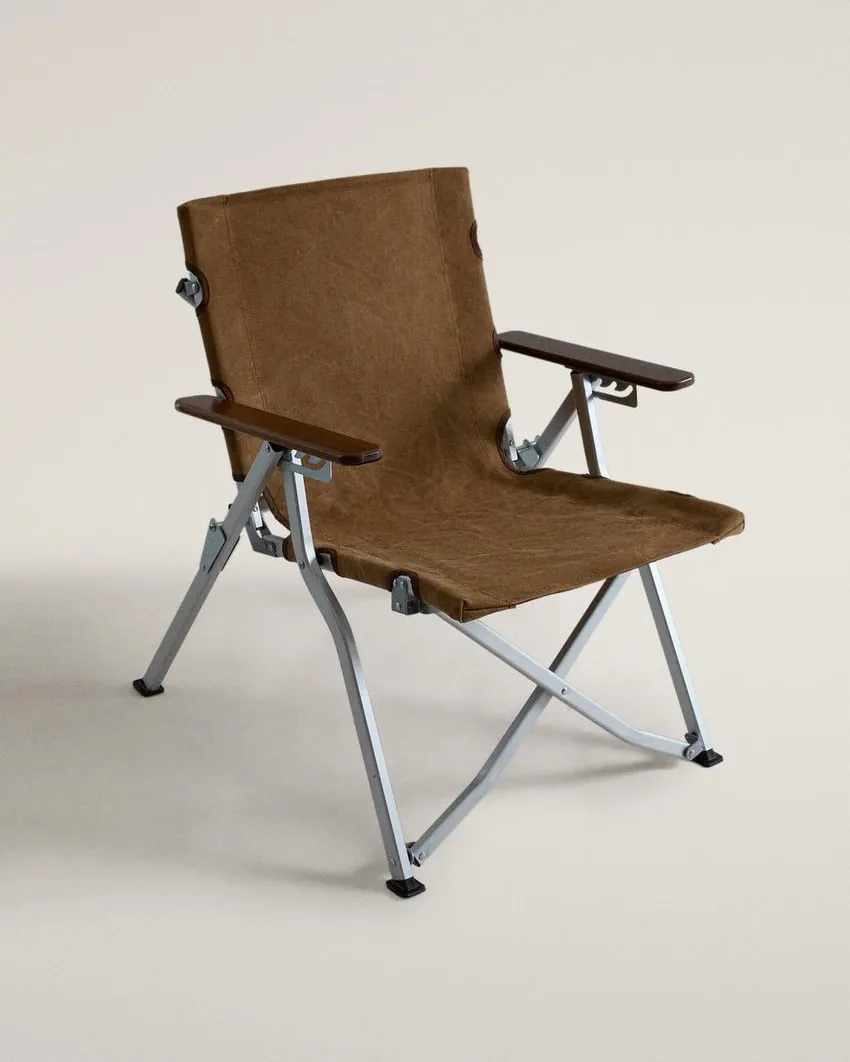 Water droplets bead on the weather-resistant aluminum surface of a lawn chair.